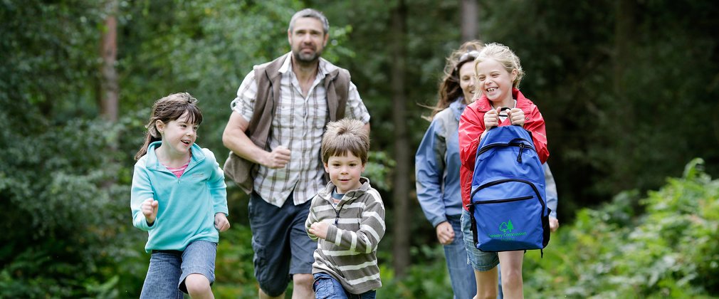 Family walking on a woodland trail