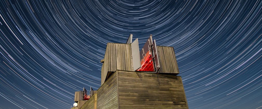 Kielder Observatory at night surrounded by stars